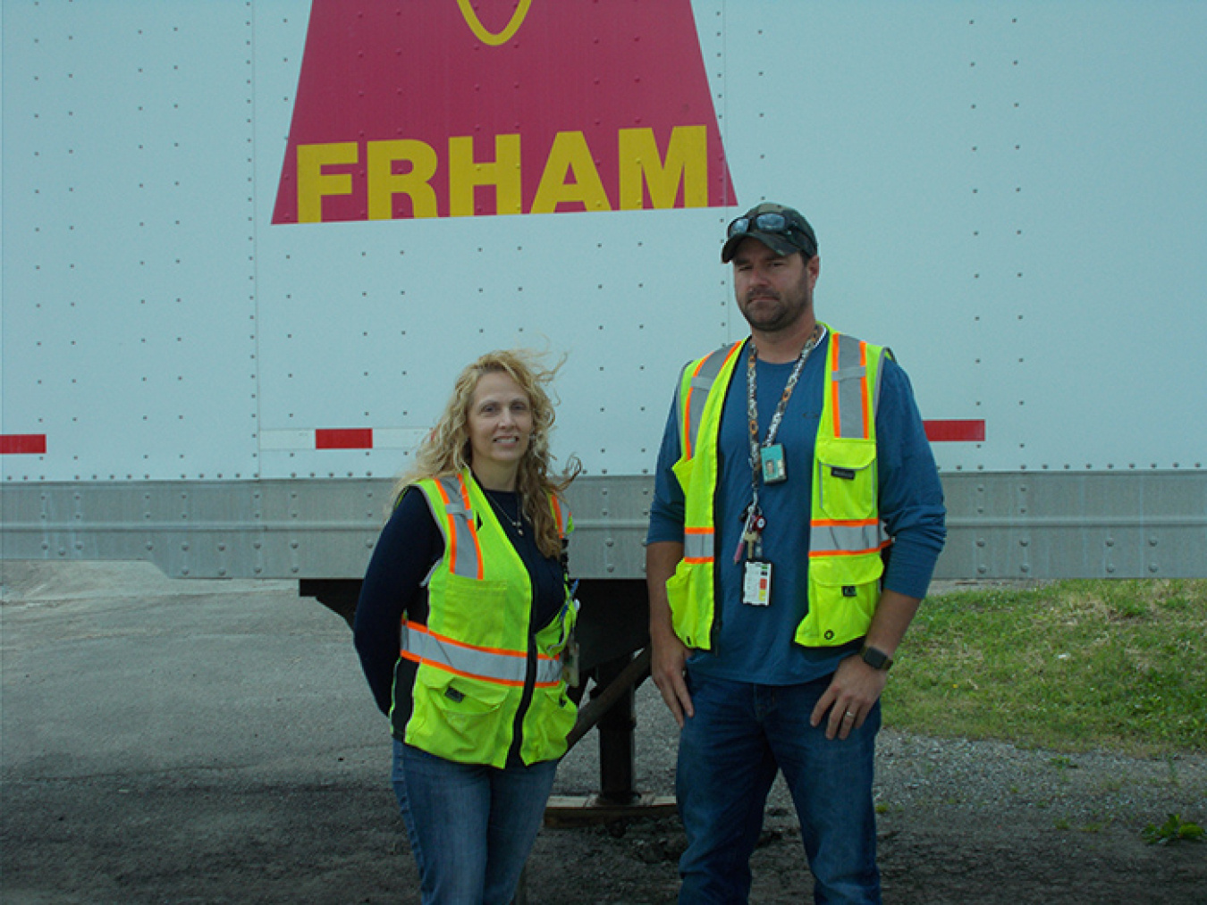 Renea Call, CH2M HILL BWXT West Valley (CHBWV) warehouse manager, and Cole Green, CHBWV demolition readiness manager, stand in front of the West Valley Demonstration Project Site’s personal protective equipment trailer.