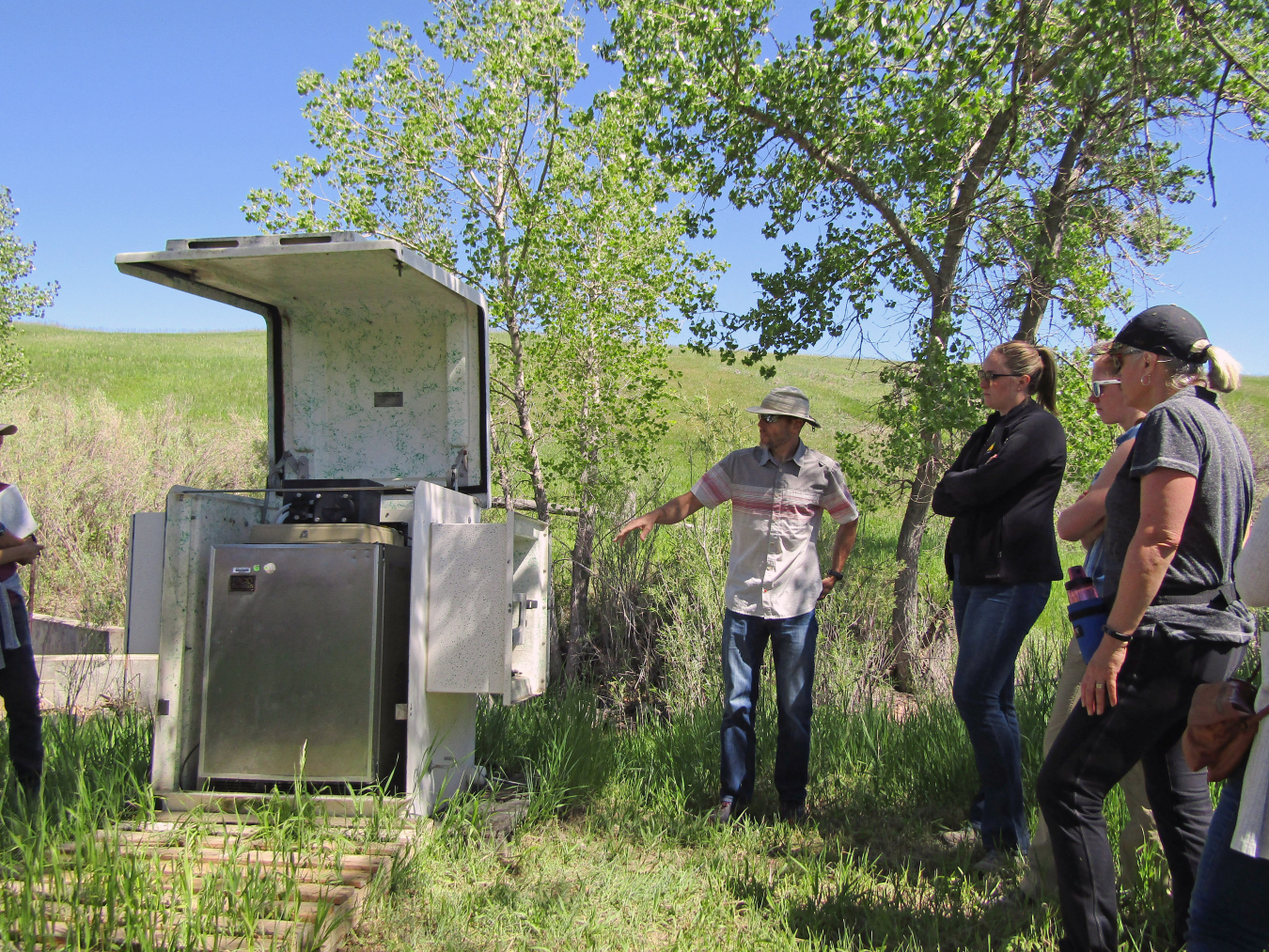 Subject matter expert, George Squibb, LM support contractor, explains surface water monitoring station during the Rocky Flats Stewardship Council tour.