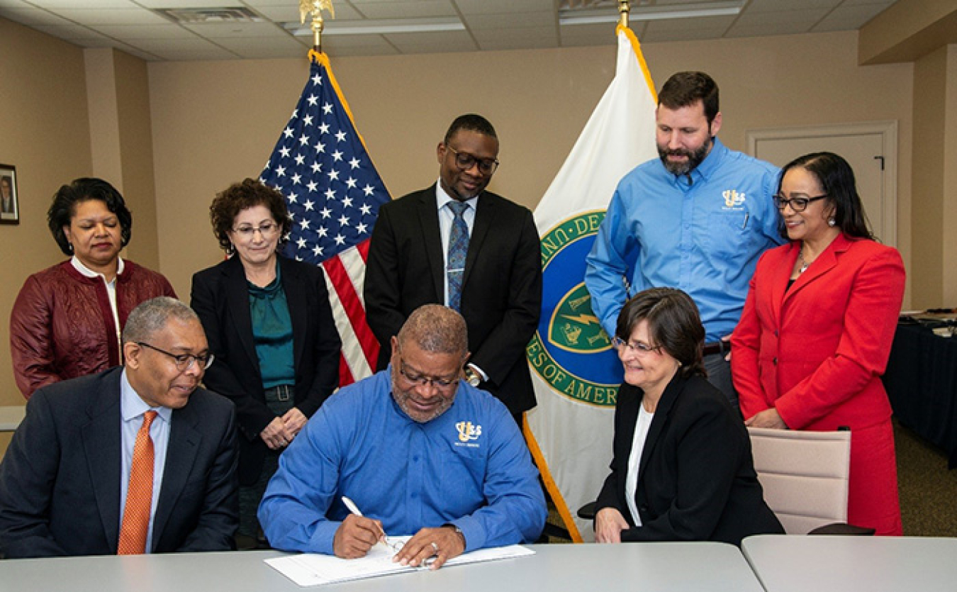 S. Richard Hagins, CEO of US&S, a small business subcontractor at the Savannah River Site, signs a mentor-protégé agreement during a Savannah River Nuclear Solutions (SRNS) Mentor-Protégé Center of Excellence team meeting. 