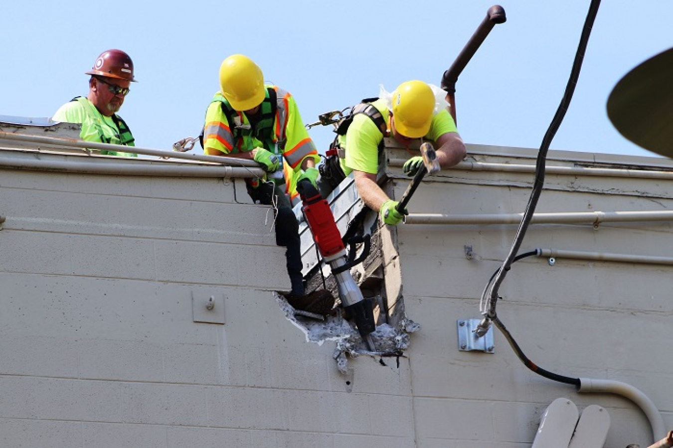 Workers carefully divide the east and west portions of Building 3017 before major demolition begins.