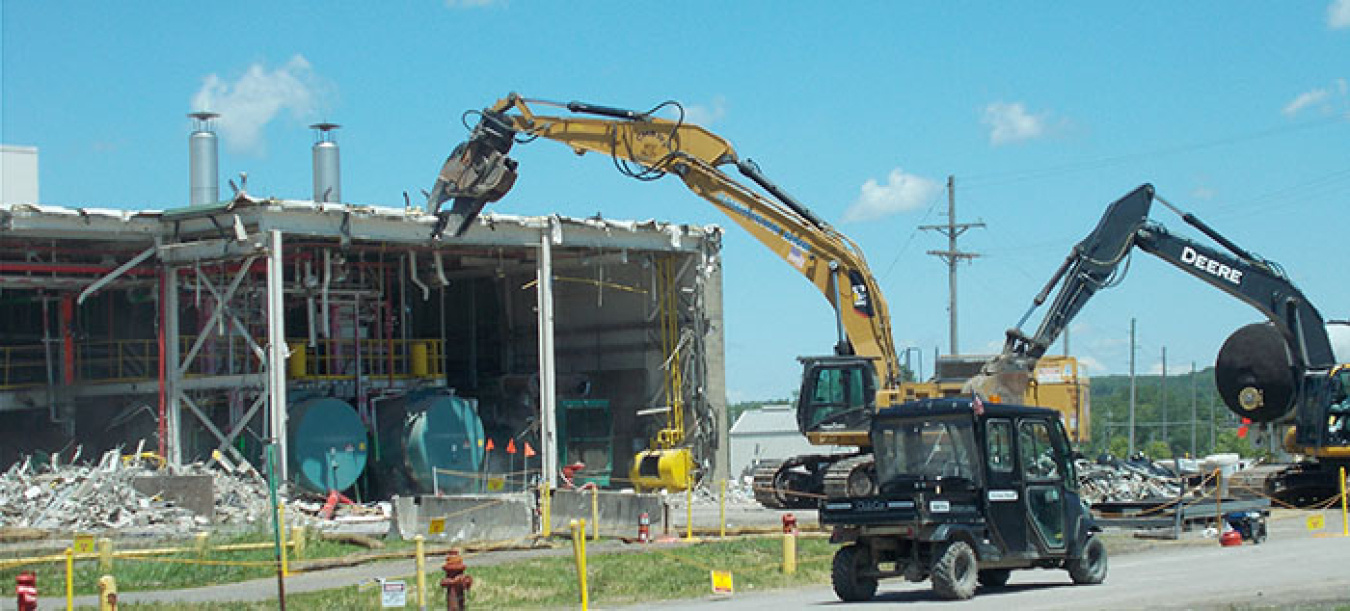 A crew demolishes two boilers at the former utility room extension building. Workers then size-reduced and packaged them for off-site disposal.