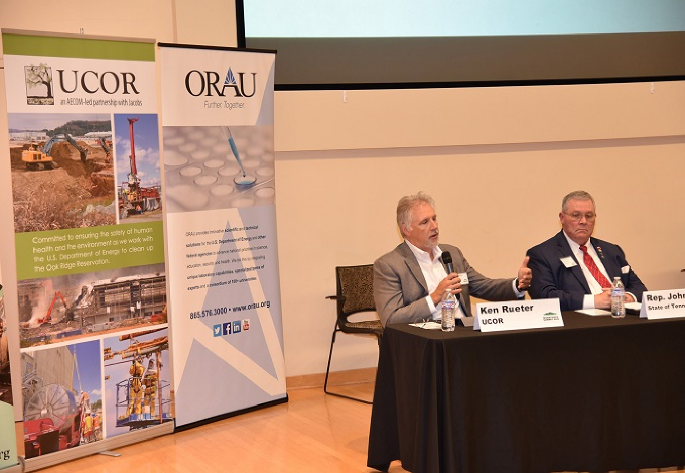 UCOR President and CEO Ken Rueter speaks at the 2019 East Tennessee Workforce Summit about his company’s approach to workforce development. Tennessee State Rep. John Ragan is at right.