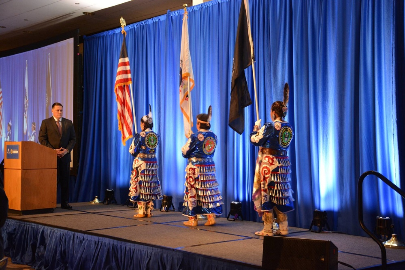 Photo of three women holding the U.S. flag.