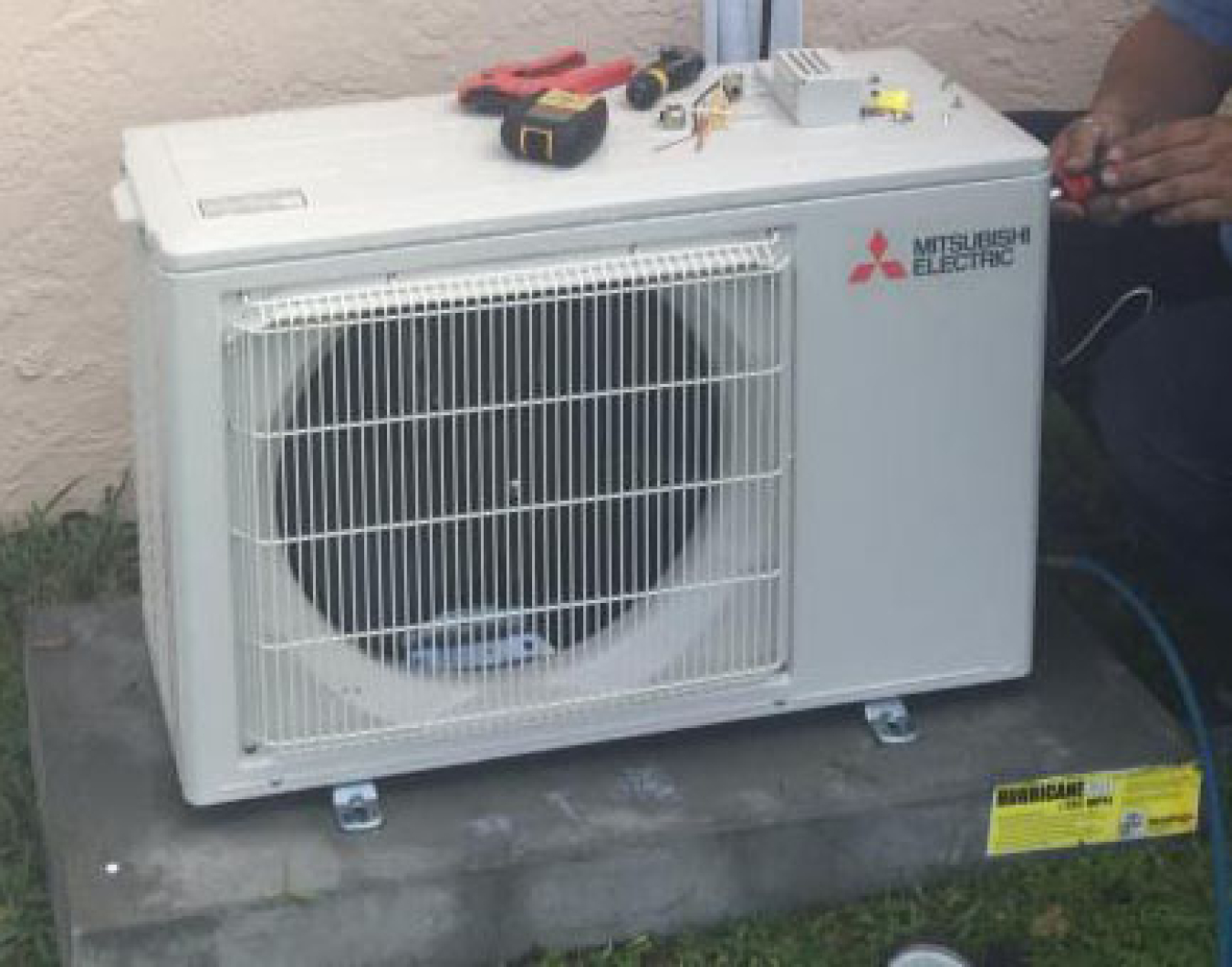 Photo of the mini-existing heat pump outside.