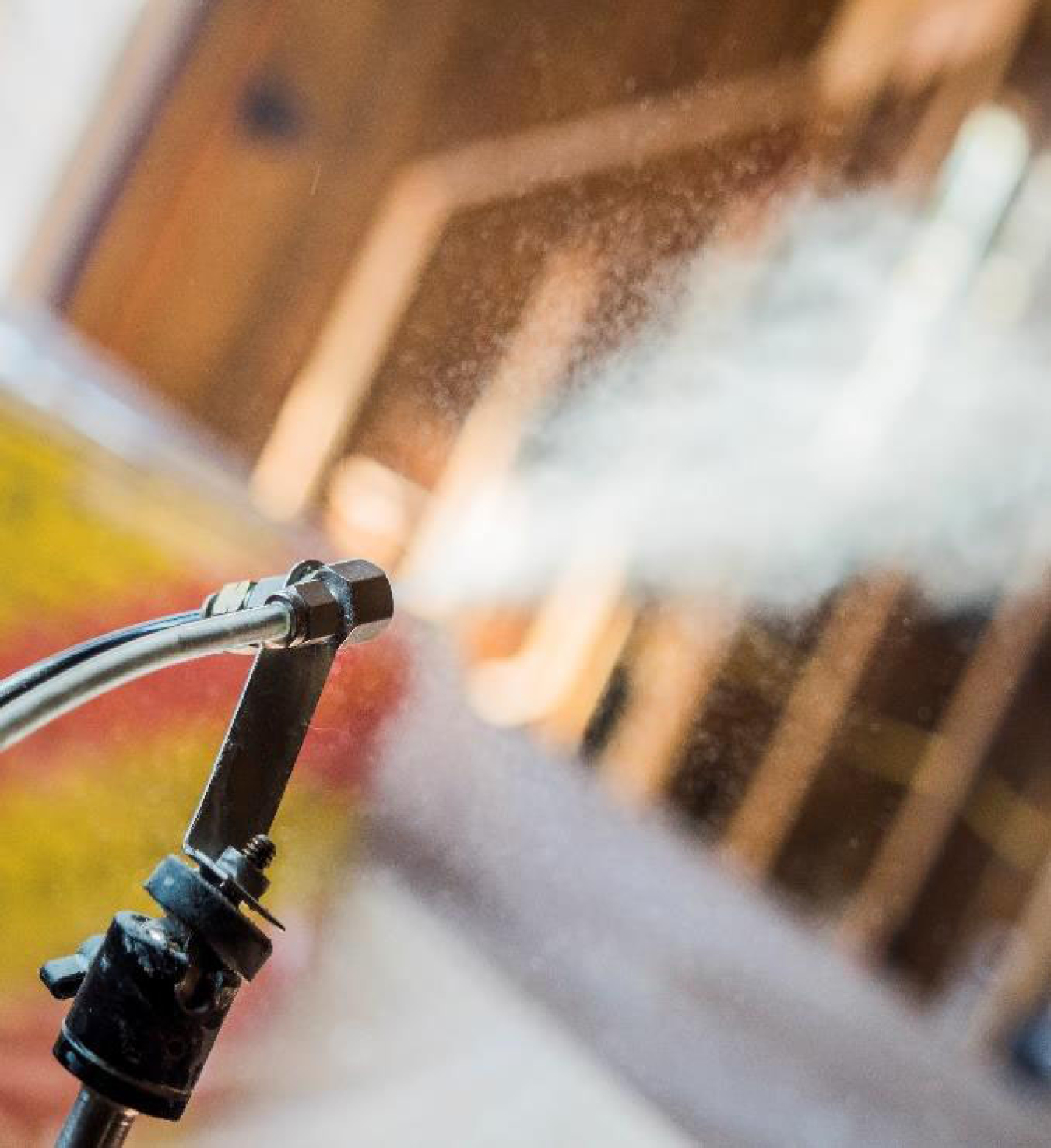 Photo of a hose spraying on a home.