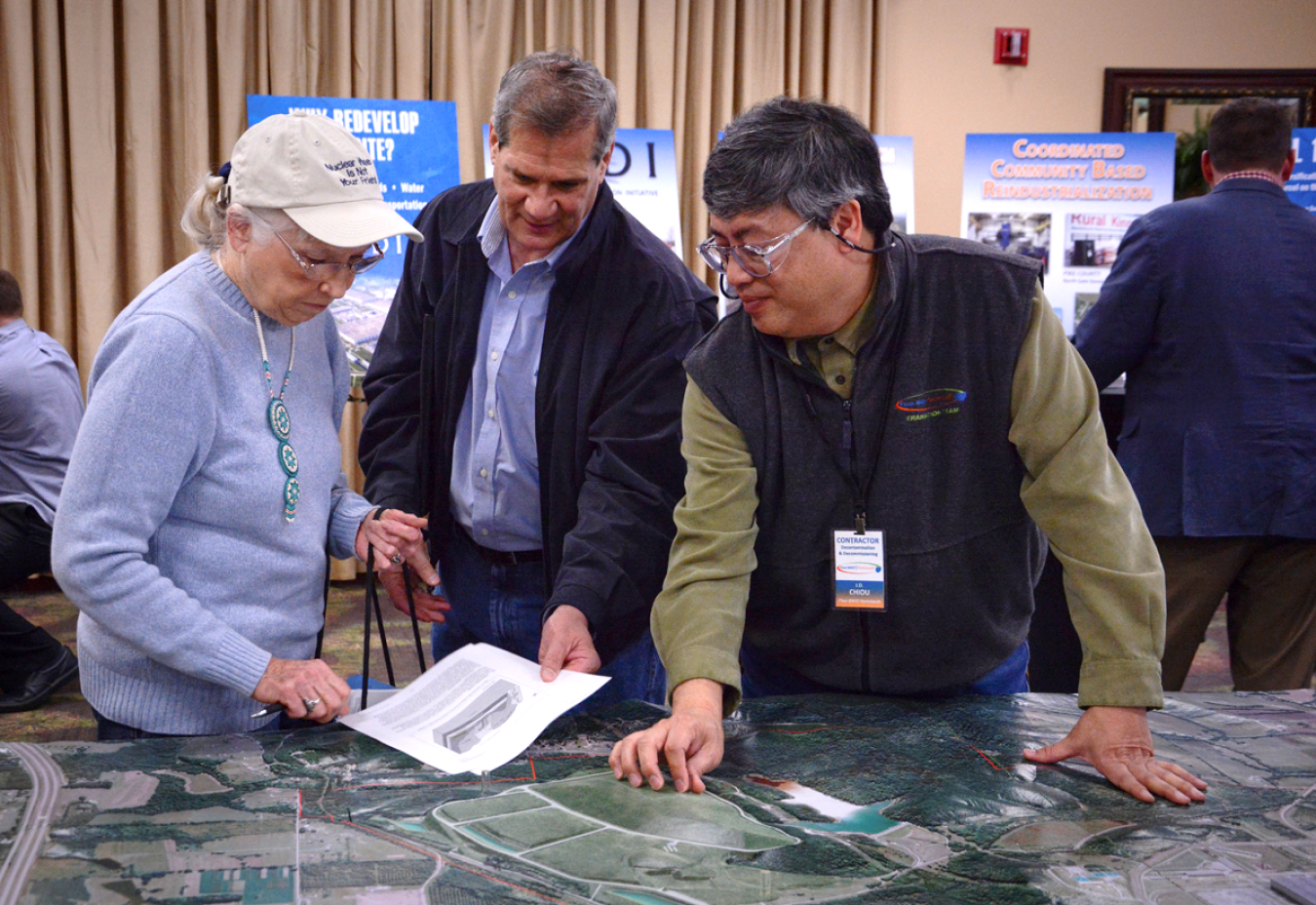 A DOE contractor discusses the Portsmouth On-Site Waste Disposal Facility with local residents during a community Open House event.