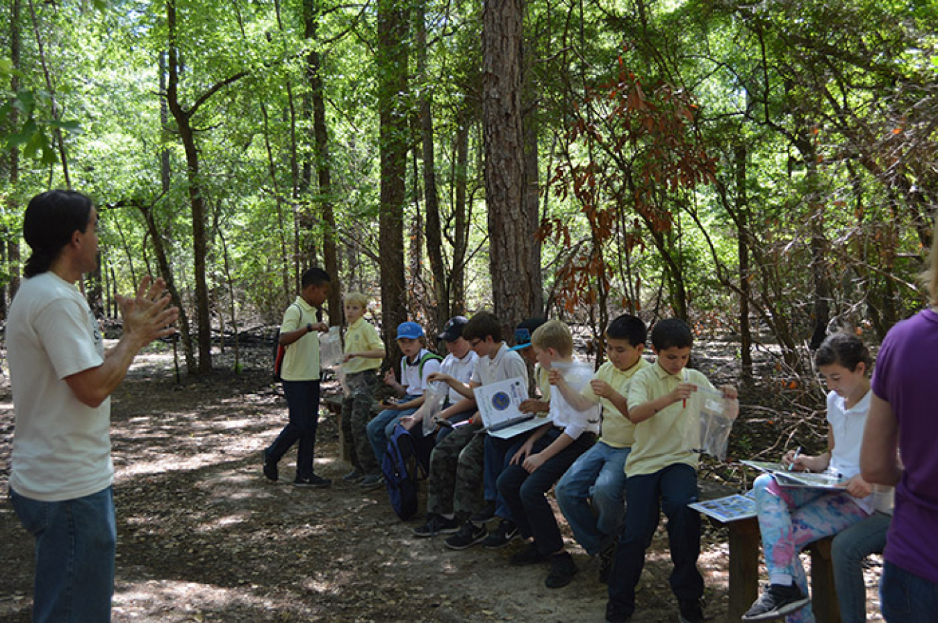 Sean Poppy, outreach coordinator for the University of Georgia’s Savannah River Ecology Laboratory outreach program, instructs students to use their guidebook to identify aquatic species found at Upper Three Runs Creek at the Savannah River Site.