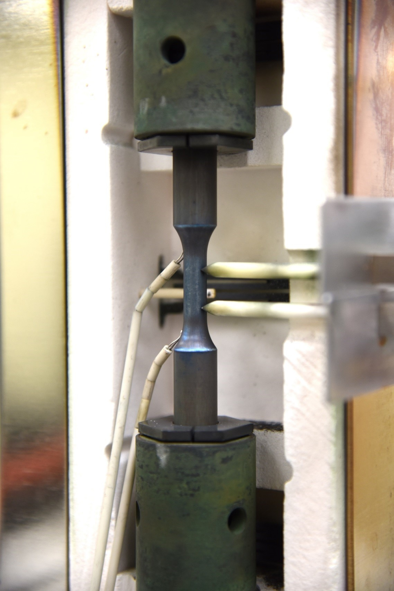 A component loaded in a furnace with thermocouple wires 
