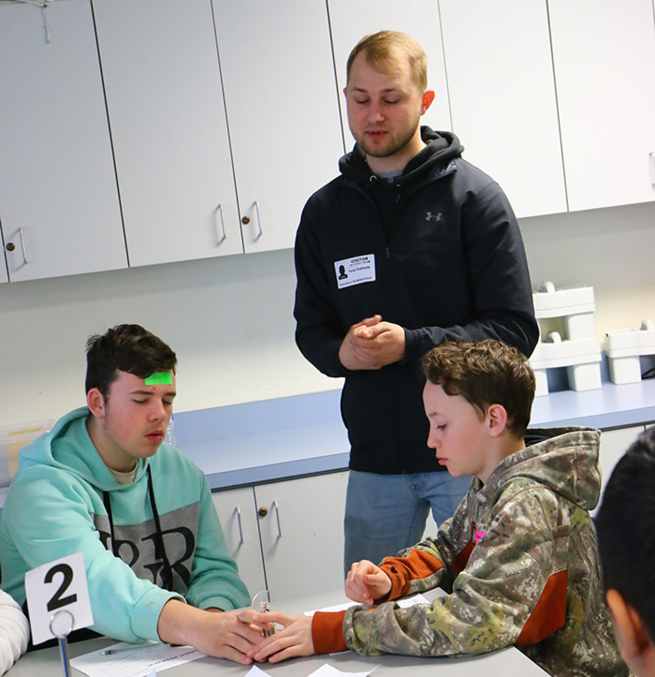 Yuriy Dubinets, a mechanical engineer with EM Richland Operations Office contractor Mission Support Alliance, demonstrates to local middle school students how a Stirling engine uses heat to operate.