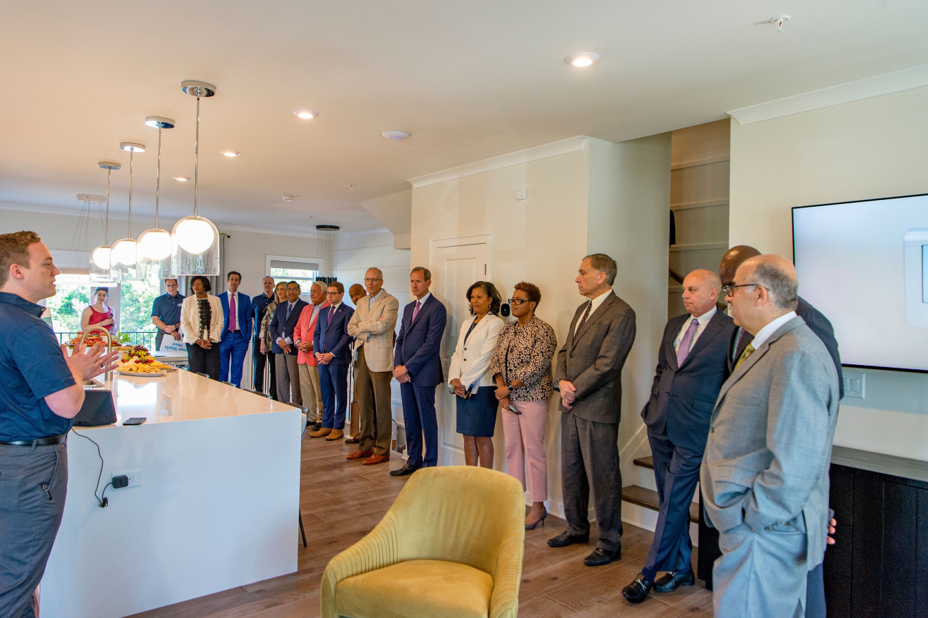 Representatives from DOE, Southern Company, Georgia Power, PutleGroup, Georgia Public Service Commissioners, EPRI, and the City of Atlanta join the new homeowners on a tour of a smart town home in the Altus community.