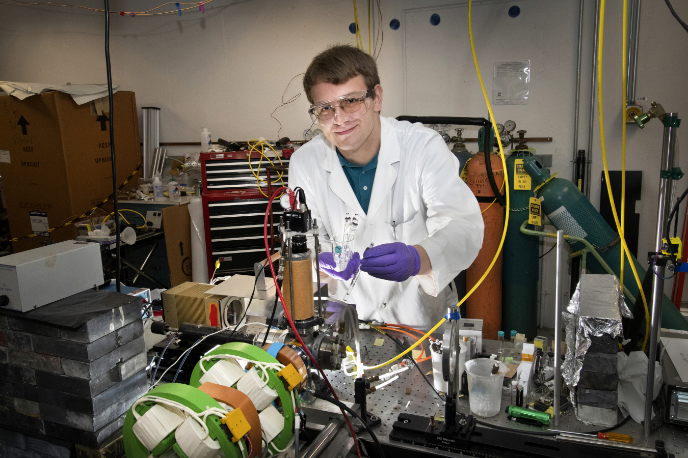 intern Christopher Hayes in Brookhaven Lab's Chemistry Division, where he is studying an organic polymer "doped" with clusters of the element boron to understand the energetics of electric charge transfer and escape that are relevant to solar cells.