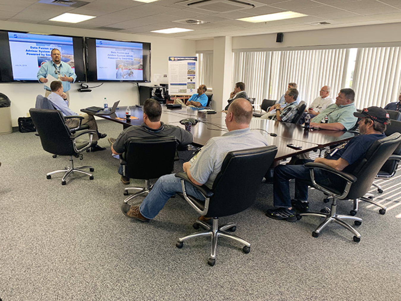 Employees at the Hanford Site watch a demonstration of the new data compilation tool.