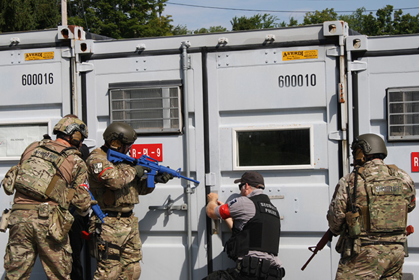 Participants in a simulated emergency response exercise at the West Valley Demonstration Project prepare to enter an office trailer that may contain a mock intruder.