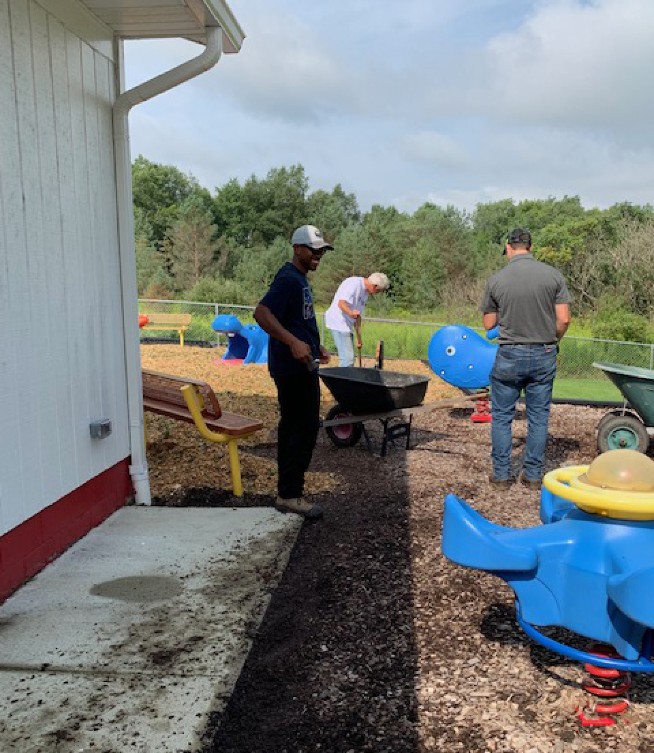 West Valley Demonstration Project employees cleared weeds, cleaned, and placed new mulch on the playground at Delevan Head Start.