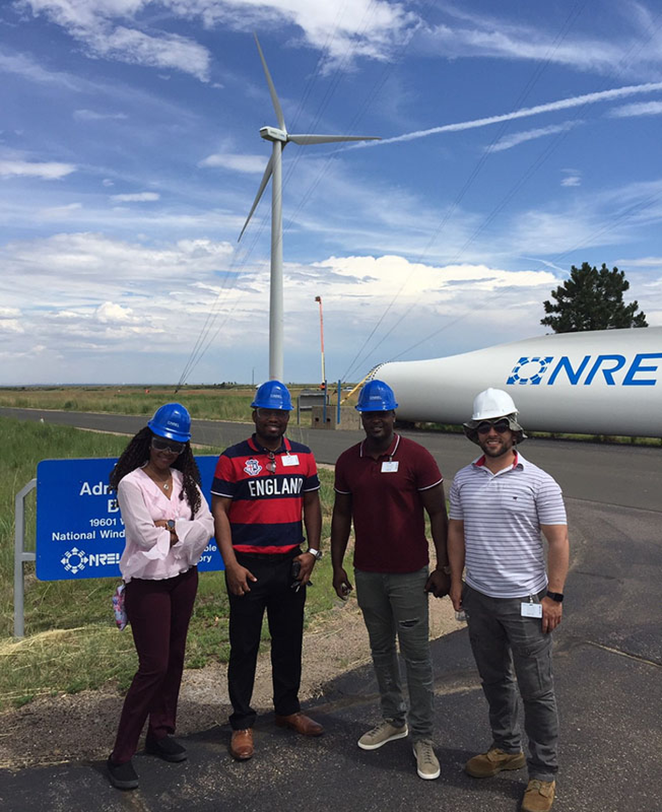 FEMP veterans standing in front of a wind turbine at the National Renewable Energy Laboratory.