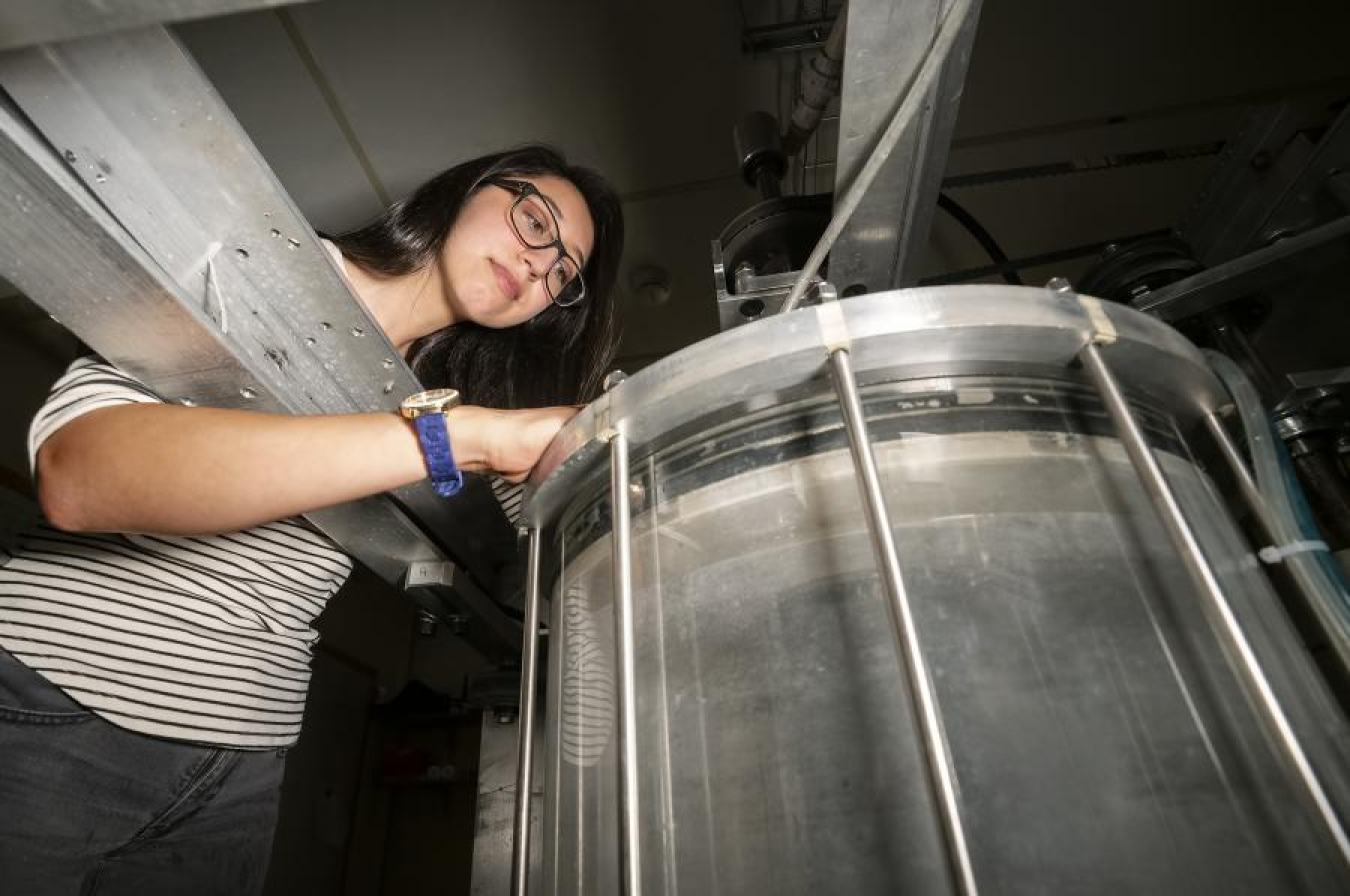 Barbara Garcia, a Science Undergraduate Laboratory Internships program participant at PPPL during the summer, peers into the liquid centrifuge.