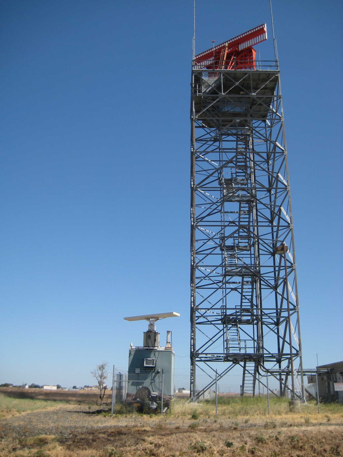 radar tower against a blue sky.