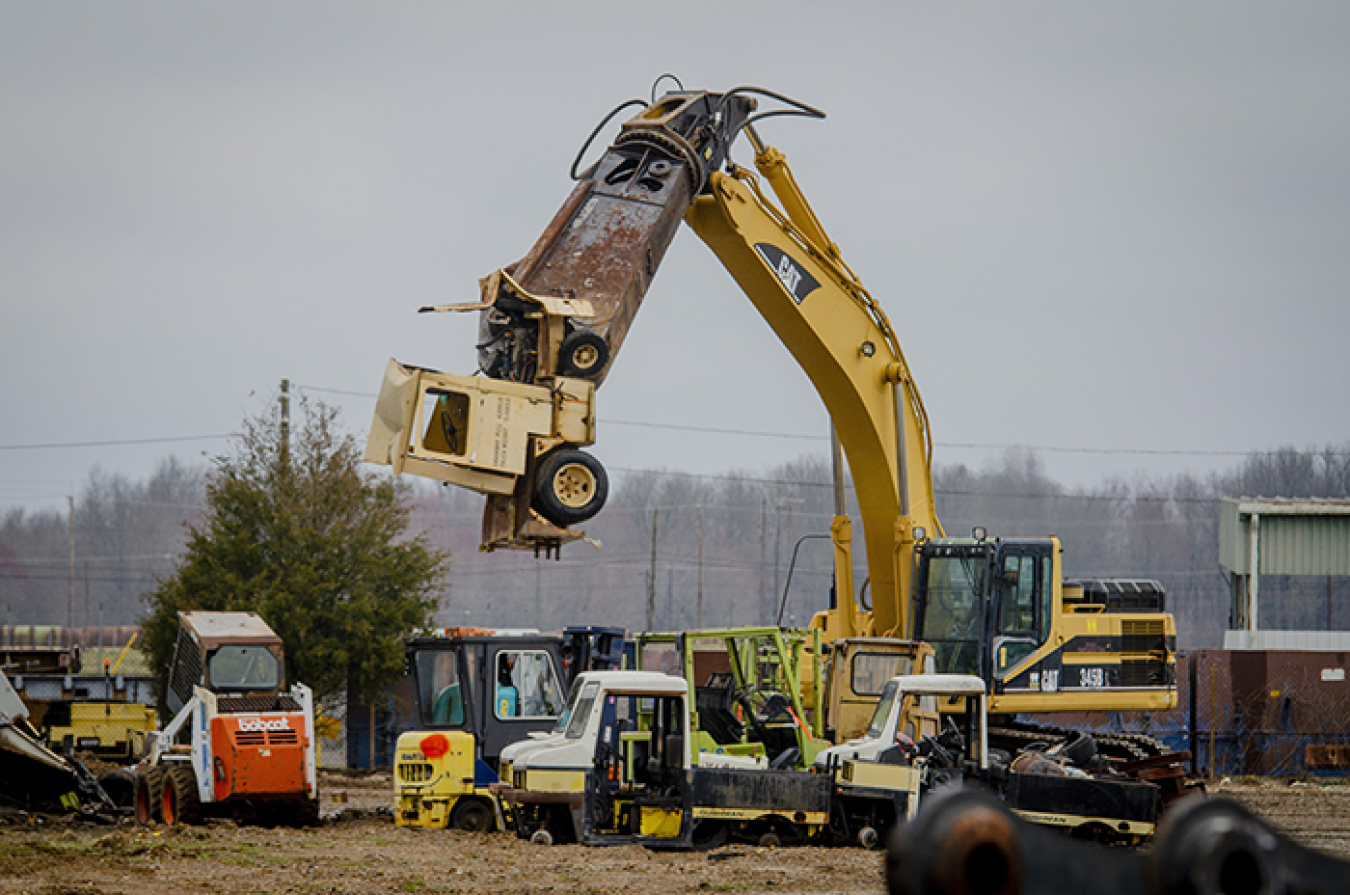 Four Rivers Nuclear Partnership Heavy Equipment Operator Brad Langston begins to shear a powered industrial truck stored at the C-740 Material Yard in order to downsize it for removal.
