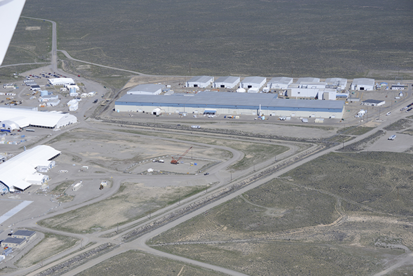 Under a proposed strategy, the Transuranic Storage Area/Retrieval Enclosure, which is the large gray building pictured here, would become the first building to be closed at the Advanced Mixed Waste Treatment Project at DOE's Idaho National Laboratory Site