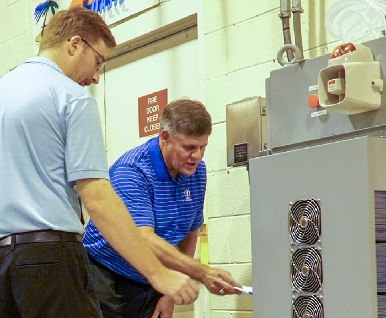 Savannah River Remediation (SRR) President and Project Manager Tom Foster, right, and SRR Senior Industrial Hygienist Alex Brown view a system that monitors air quality for potentially dangerous mercury vapors.