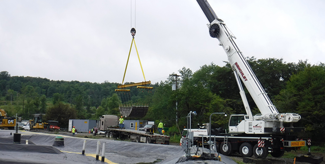 A crew moves a section of interlocking concrete blocks for placement at a closed disposal area at the West Valley Demonstration Project Site.