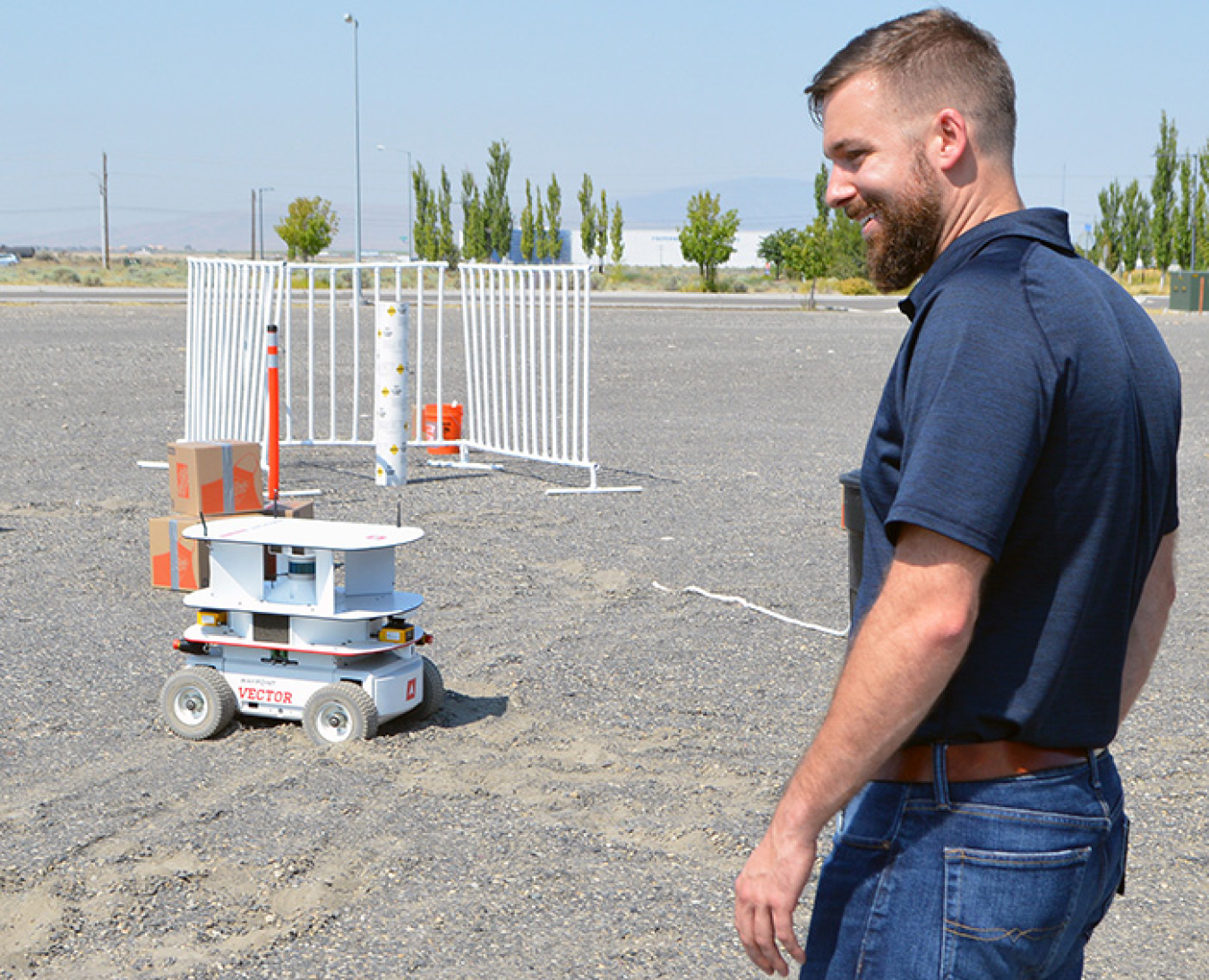 Washington River Protection Solutions (WRPS) scientist Alex Pappas watches a remote-controlled robot crawler during a recent test run. The mobile crawler can maneuver around objects and be fitted with a wide range of equipment.