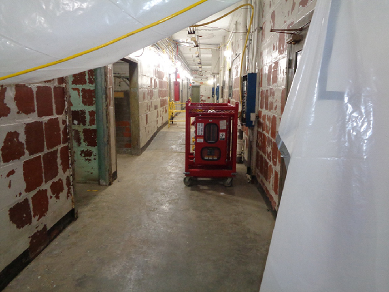 Photos show a hallway in the Biology Complex before, at top, and after Oak Ridge crews completed asbestos abatement.