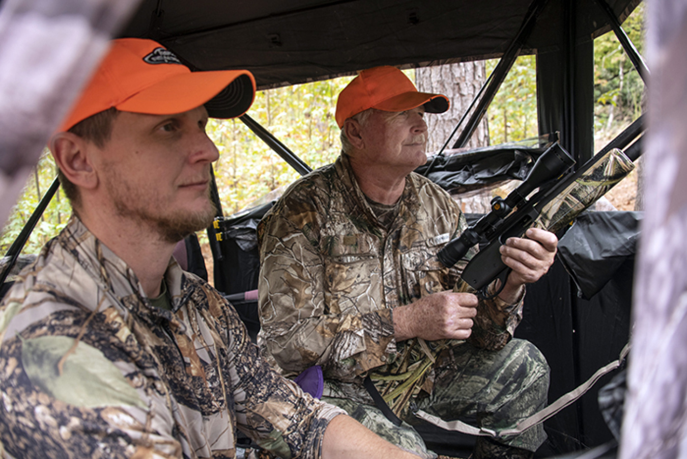 Robert Starnes, right, a U.S. Army veteran, waits with his son, Rob Starnes, as they look and listen for wild hogs and deer during the 20th annual deer hunt at the Savannah River Site.