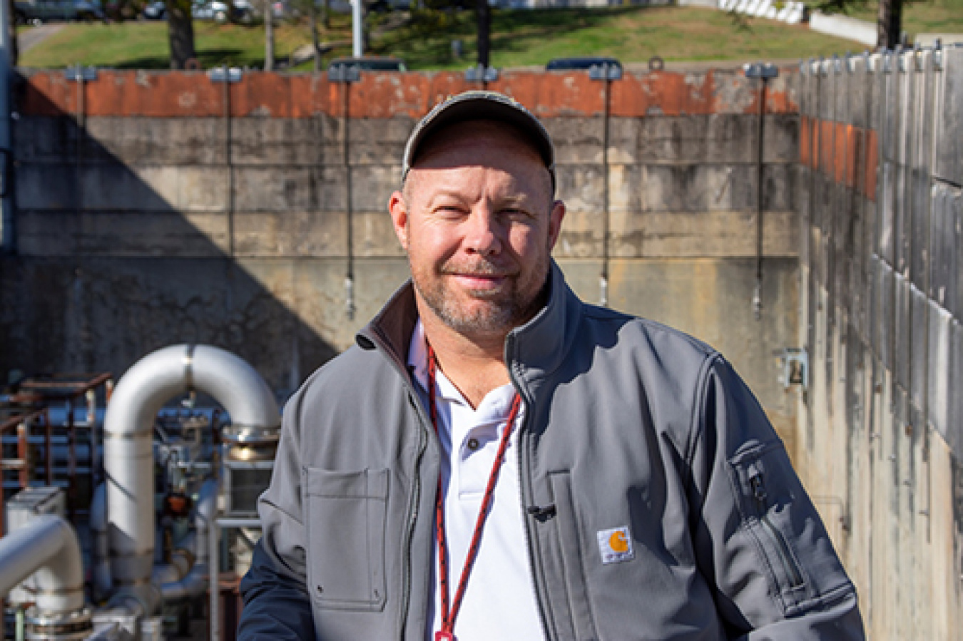 After serving in the U.S. Marine Corps, Henry Mutka earned a mechanical engineering degree and joined DOE’s Oak Ridge Office of Environmental Management in 2018. He is pictured here with infrastructure he helps oversee at the Oak Ridge National Laboratory