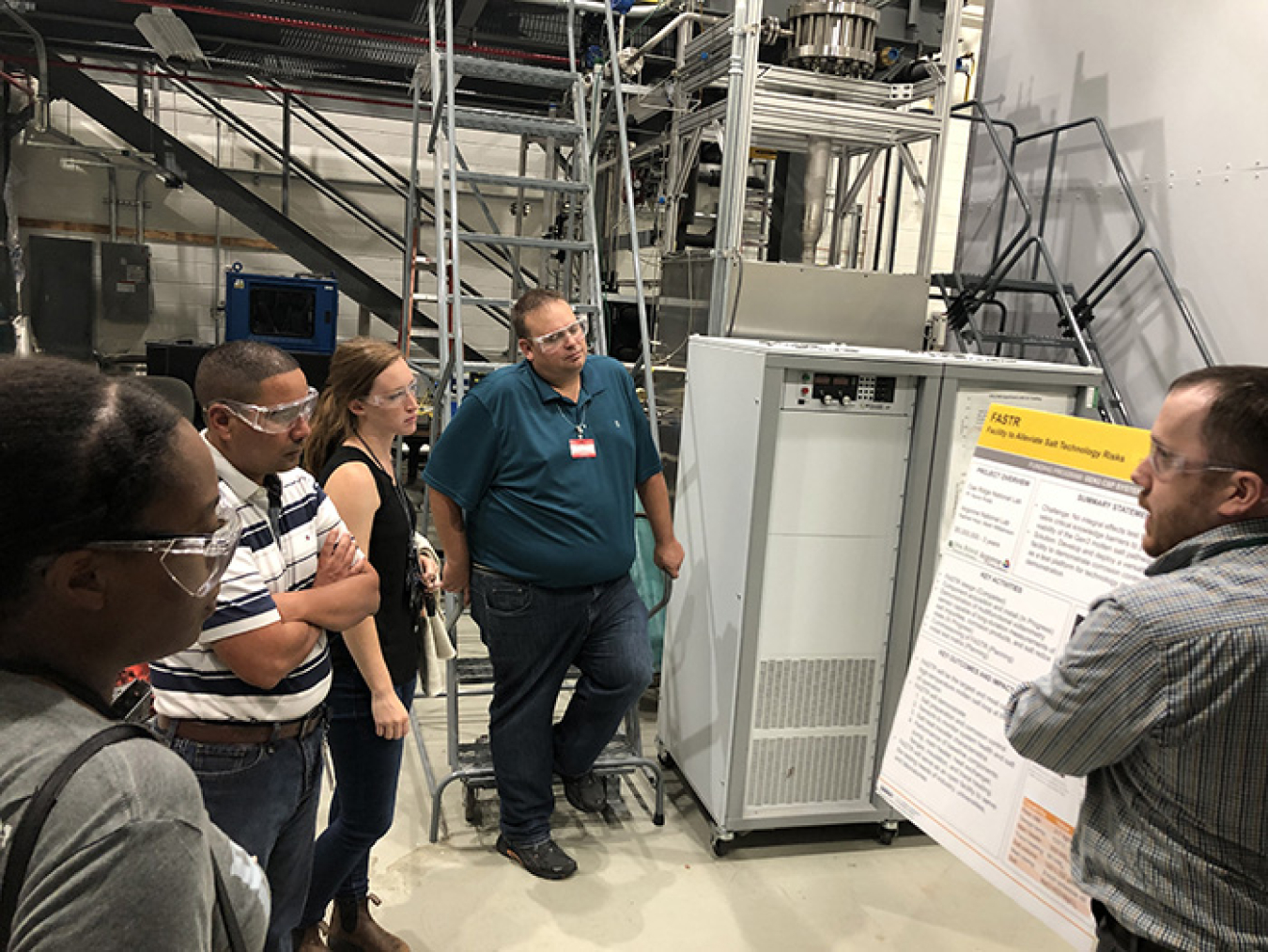 Molten Salt Reactor Experiment (MSRE) System Engineer Melanie Lindsey, third from left, leads delegates from the Nuclear Regulatory Commission and Ontario Power Generation on a tour of the reactor test loop and reactor corrosion laboratory at Oak Ridge.