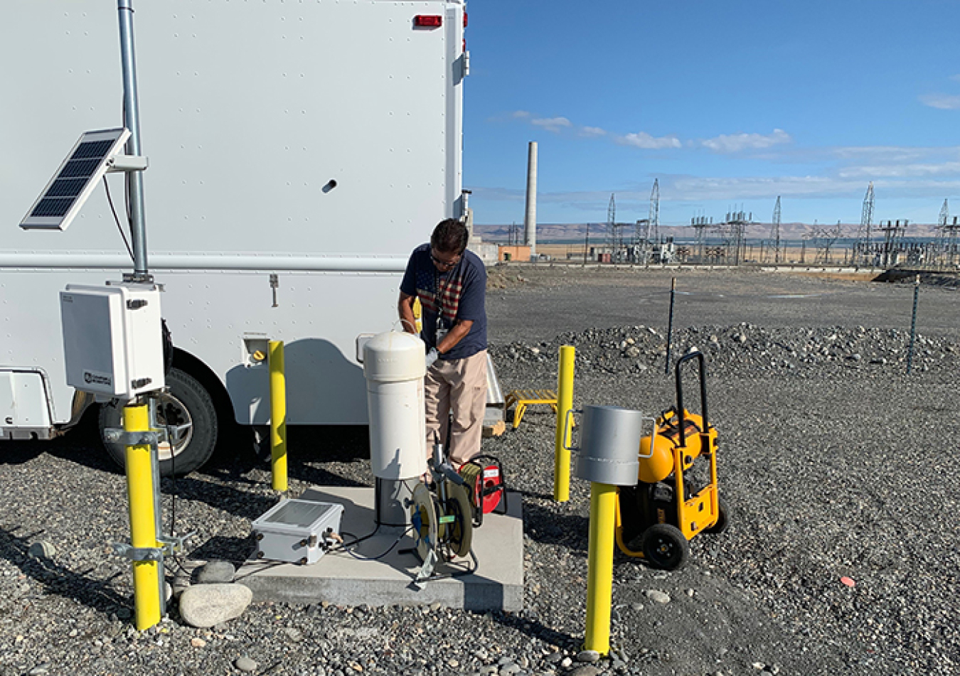 Juan Aguilar with Hanford contractor CH2M HILL Plateau Remediation Company prepares to take a groundwater sample from a well at a soil treatability test site in Hanford’s 100 K Area.