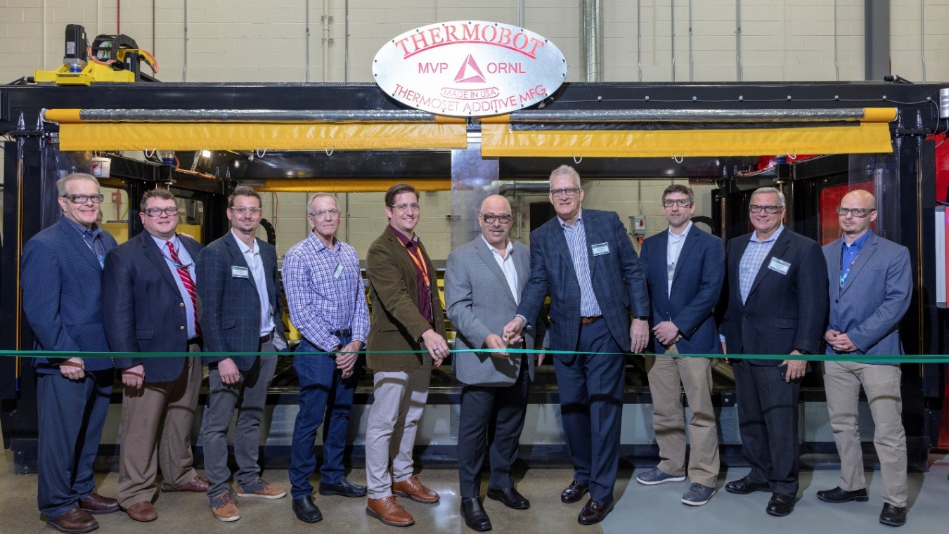 Moe Khaleel, center (left) ORNL Associate Laboratory Director, Energy and Environmental Sciences Directorate and Bob Vanderhoff, center (right) CEO, Magnum Venus Products, cut the ribbon on MVP’s thermoset printer at DOE’s Manufacturing Demonstration Faci