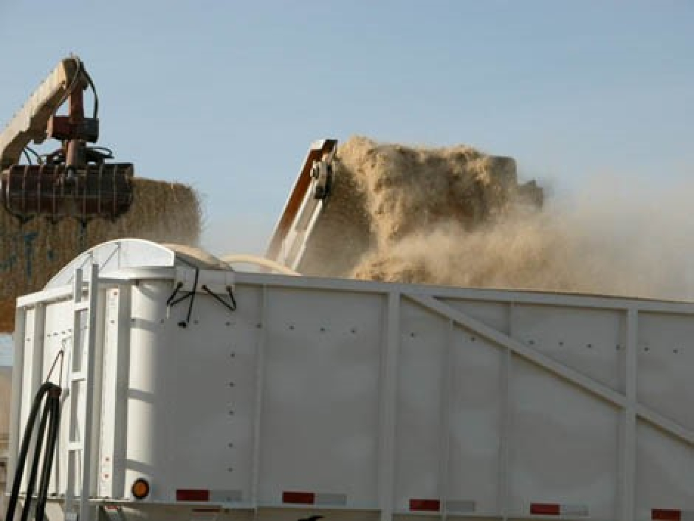 In this photo, preprocessed biomass is being loaded into a trailer that will either deliver the biomass feedstock to a biorefinery or will act as a temporary storage container for the biomass.