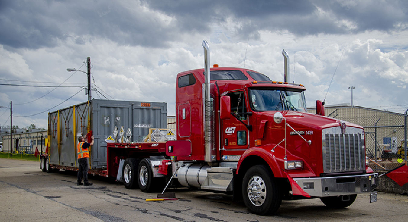 Workers secure a container to ship the first cold trap from the EM Paducah Site.