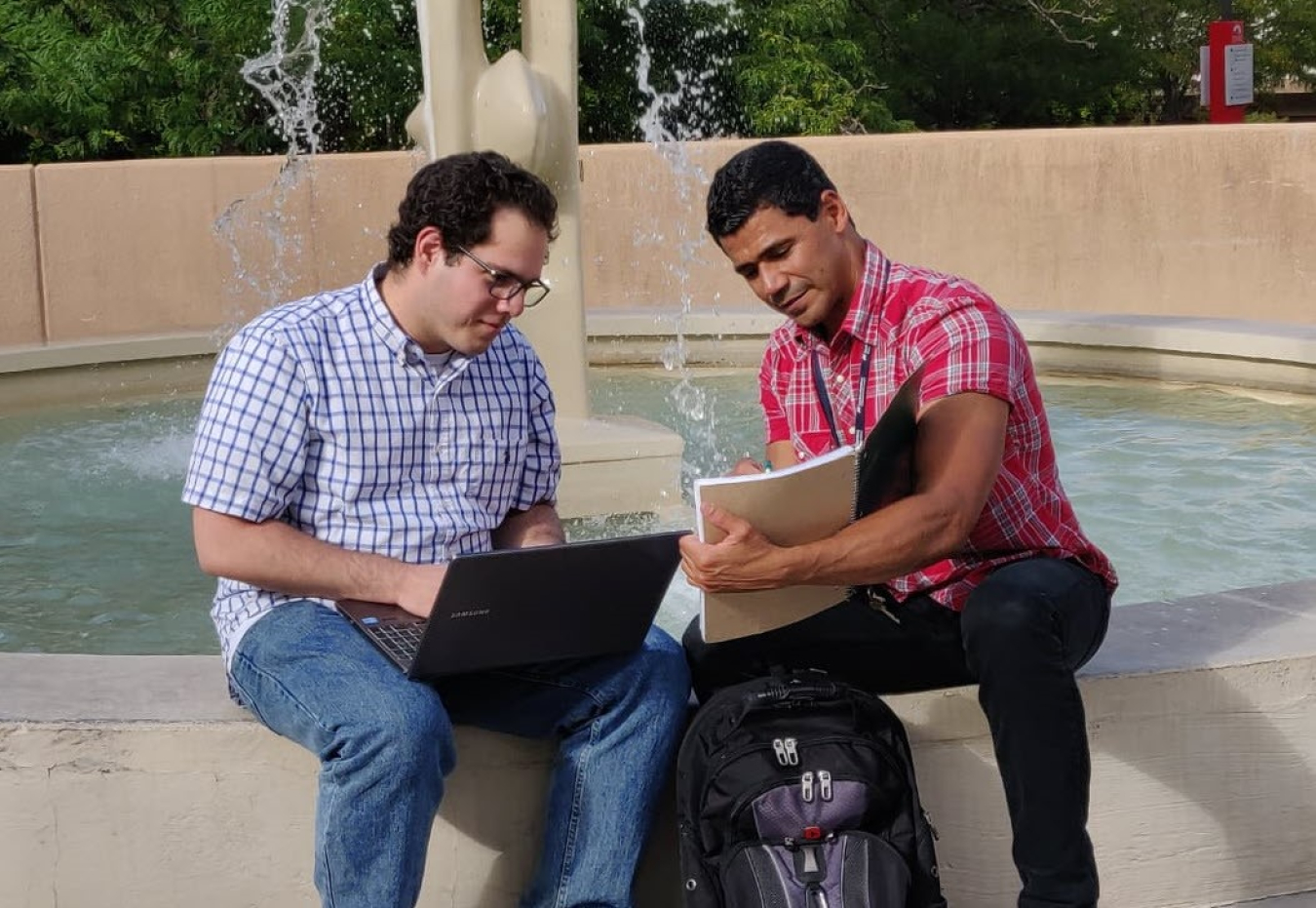 Edgardo Desarden Carrero, right, talks with Melvin Lugo Alvarez, both summer interns from the University of Puerto Rico, Mayagüez, studying resilient energy systems at Sandia National Laboratories.