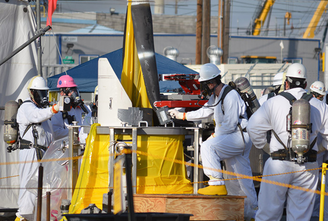 Washington River Protection Solutions radiation control specialists take readings as a pump is pulled from Hanford tank AP-102 to prepare for waste feed delivery operations.