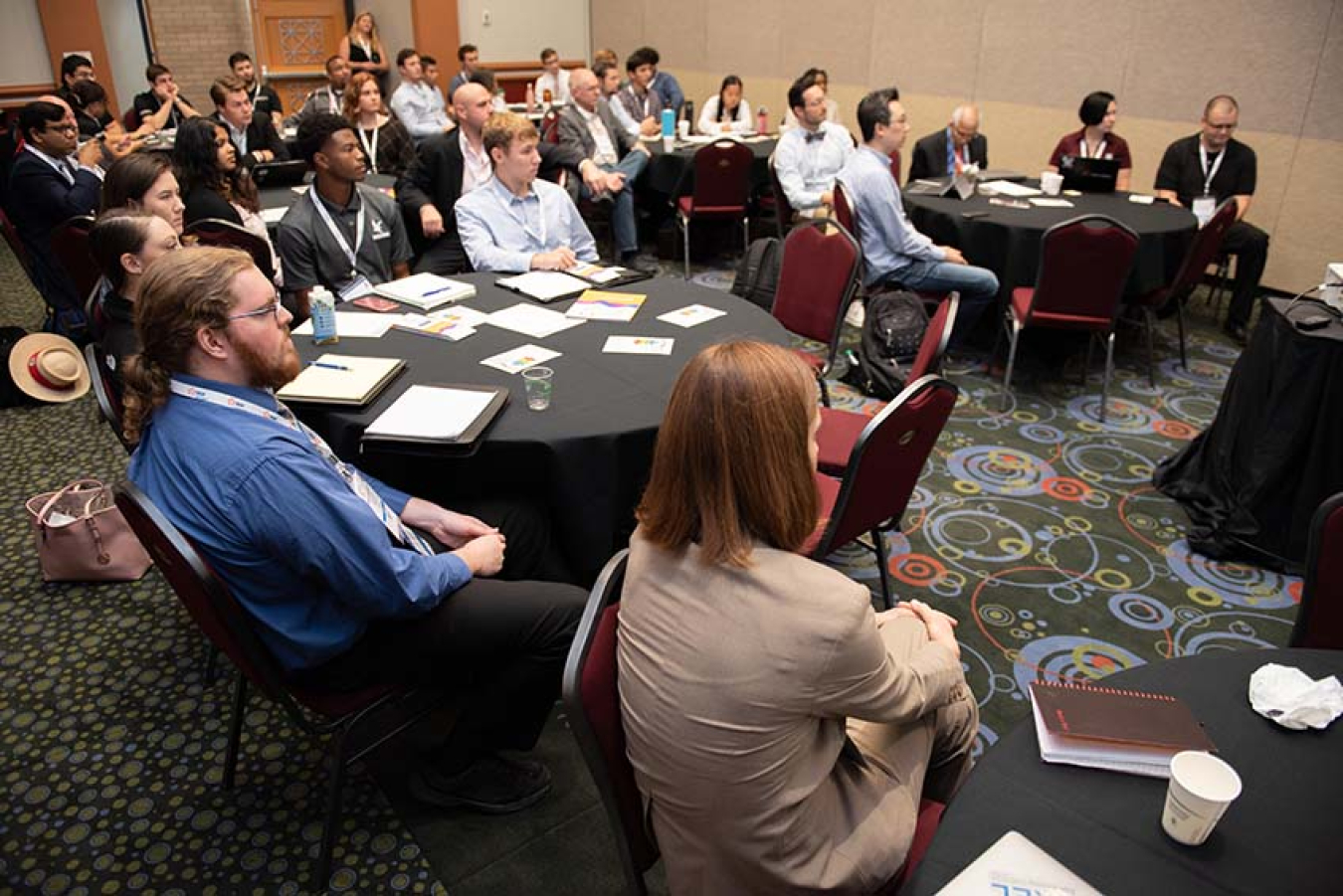 Students and faculty advisors listen intently as Solar District Cup organizers present at the Warmup Workshop at Solar Power International.