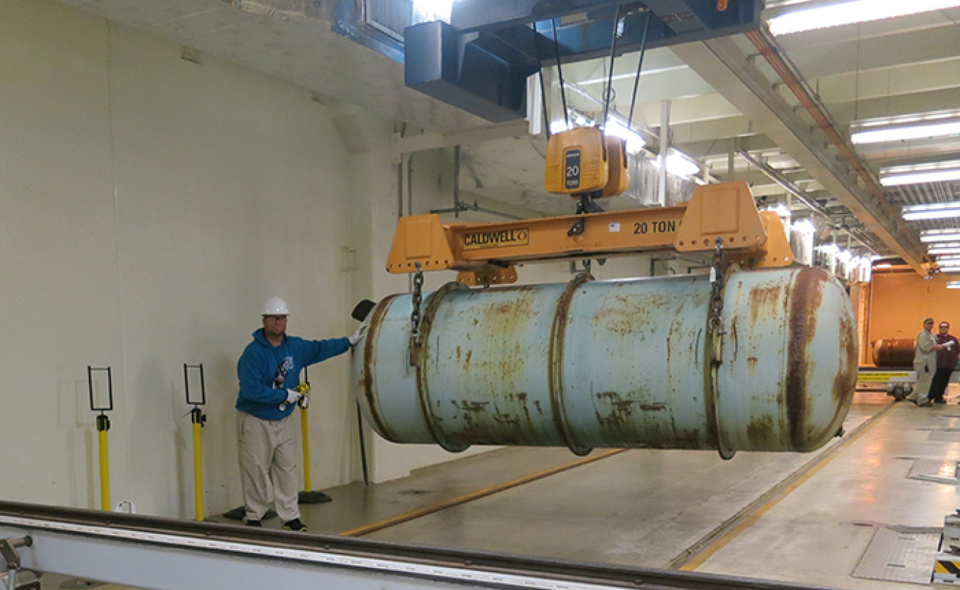 Nathan Maynard, an operations technician with Mid-America Conversion Services, moves a depleted uranium hexafluoride (DUF6) storage cylinder at the Portsmouth DUF6 conversion facility.