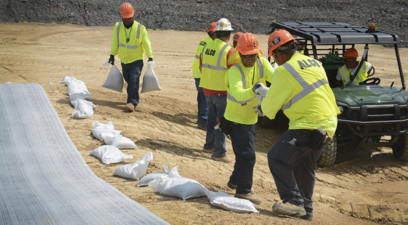 Workers for Fluor-BWXT Portsmouth's On-Site Waste Disposal Facility construction project place the facility’s first liner. 