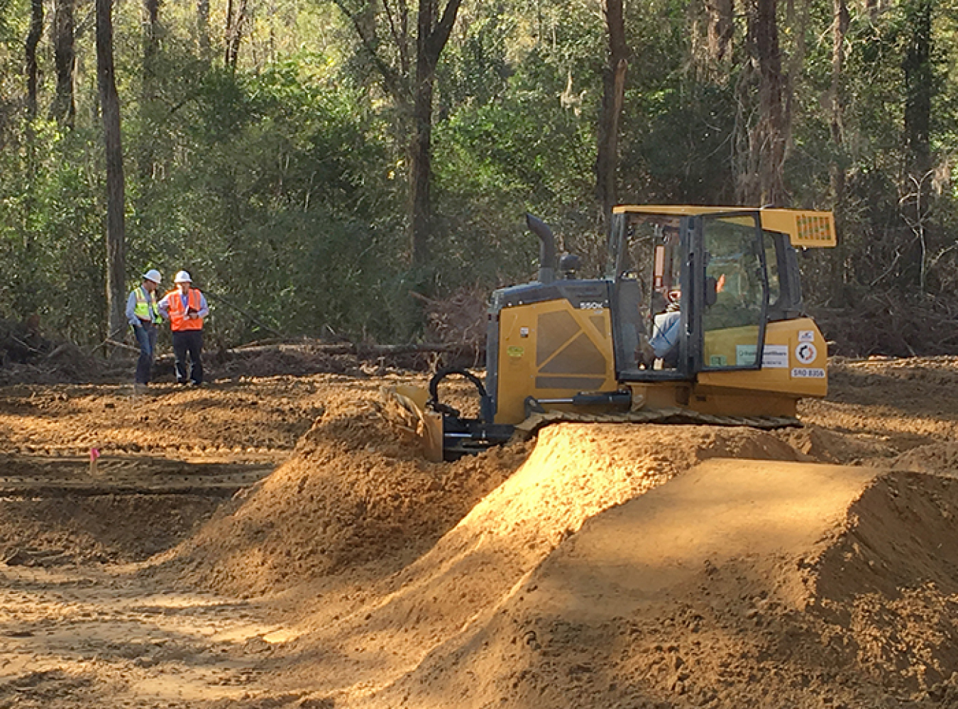 Savannah River Nuclear Solutions engineers Justin Fuller, left, and Steve Conner evaluate progress in the cleanup of a pond-like basin containing low levels of herbicides and pesticides at the Savannah River Site.