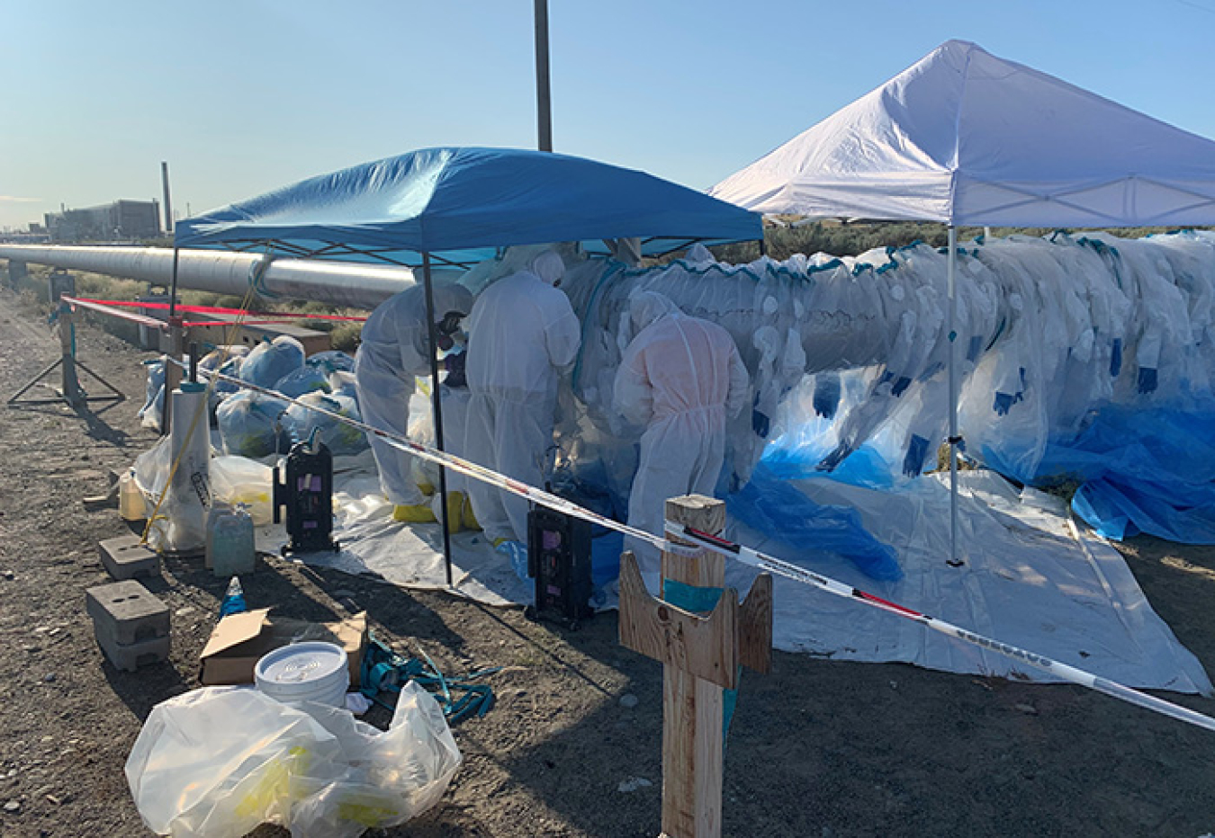 Crews recently removed asbestos-covered steam lines, at top, to allow construction of new access roads, above, to the Hanford Site’s Integrated Disposal Facility, to prepare for the eventual disposal of vitrified low-activity waste.