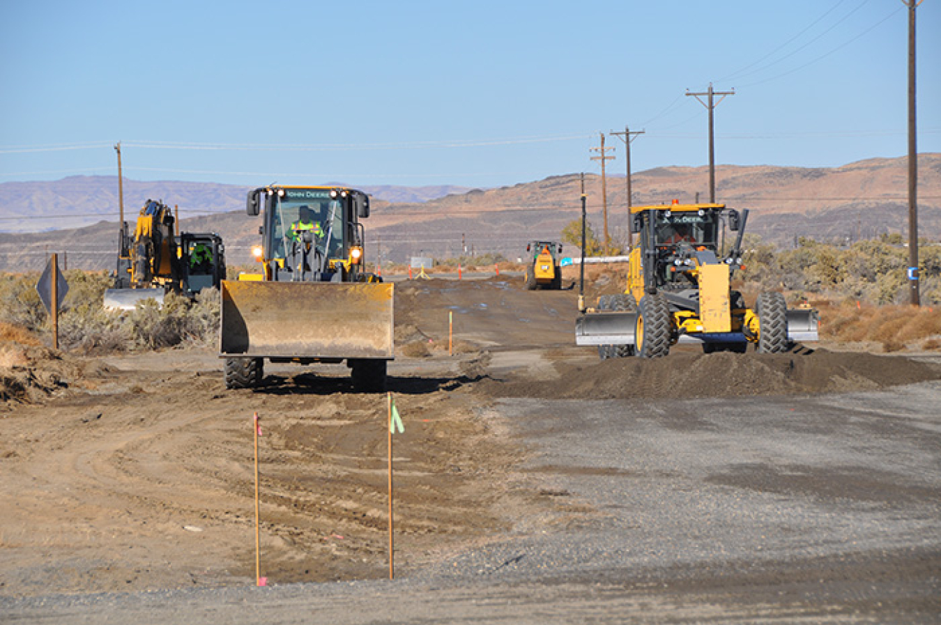 Crews recently removed asbestos-covered steam lines, at top, to allow construction of new access roads, above, to the Hanford Site’s Integrated Disposal Facility, to prepare for the eventual disposal of vitrified low-activity waste.