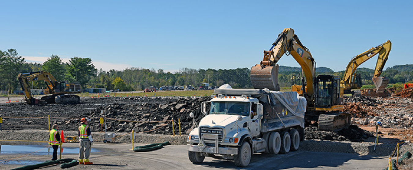 Then and now: Workers took out the large slab that remained after the K-29 gaseous diffusion building demolition, at top, and transformed the site into a grassy field, above.