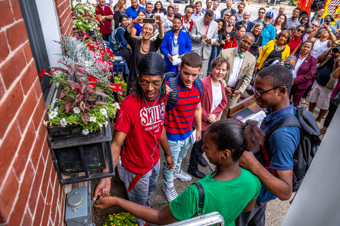 Young trainees in the Philadelphia Energy Authority solar training program flip the switch on the 150th Solarize Philly installation. 