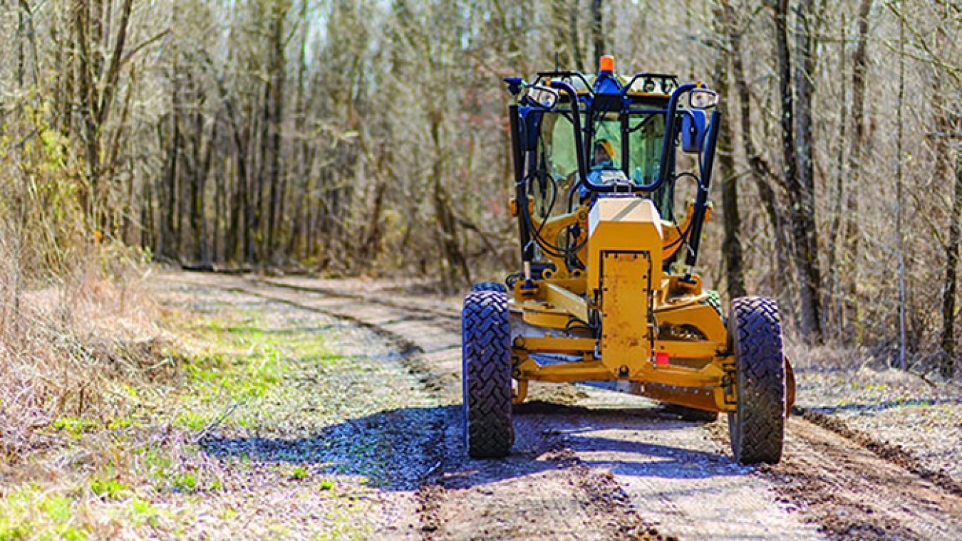 Heavy Equipment Operator Jeff Walls grades one of the 32 miles of roads maintained by Swift & Staley Inc. at the Paducah Site.