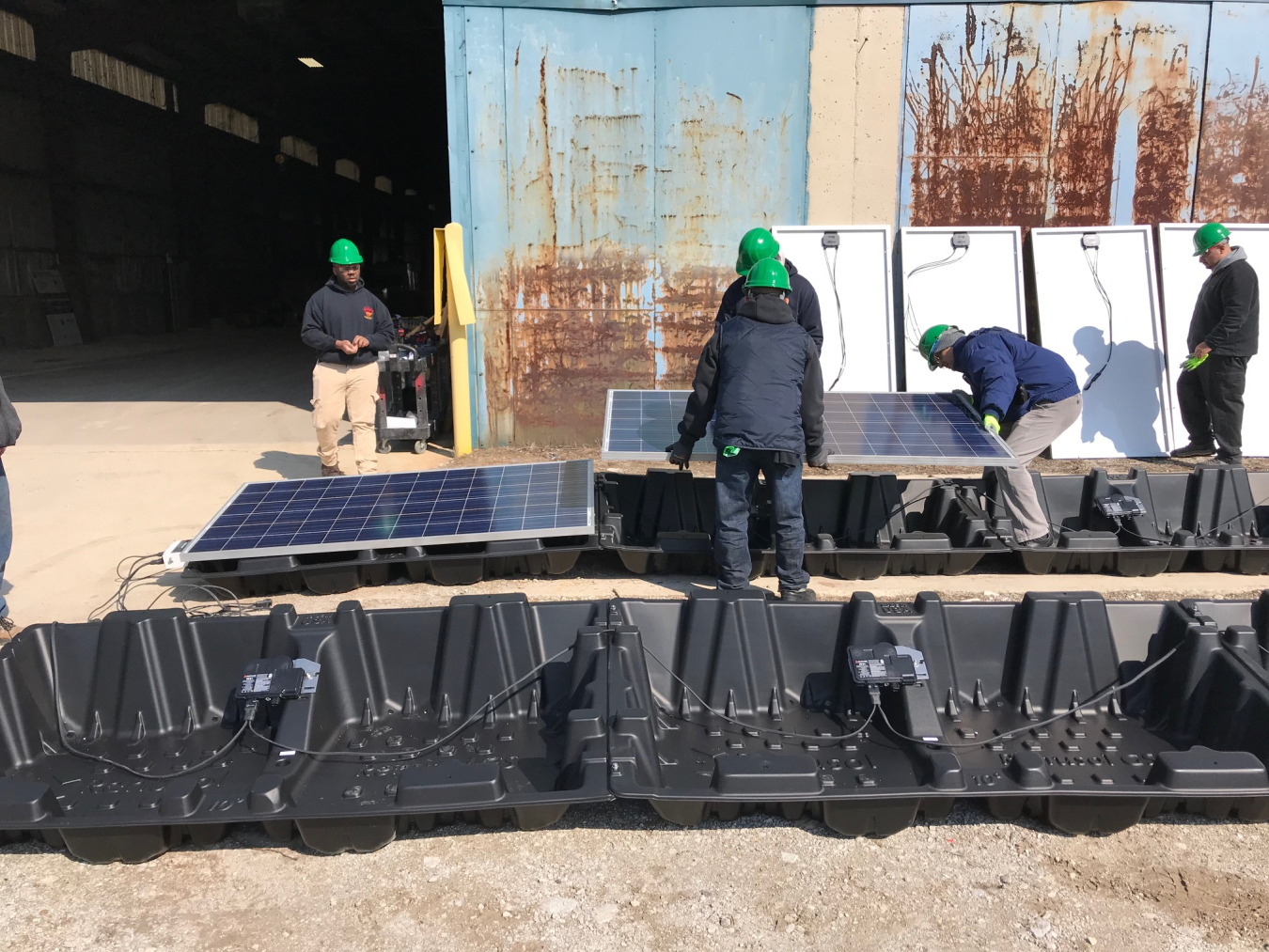 Program participants readying solar panels for shipping.