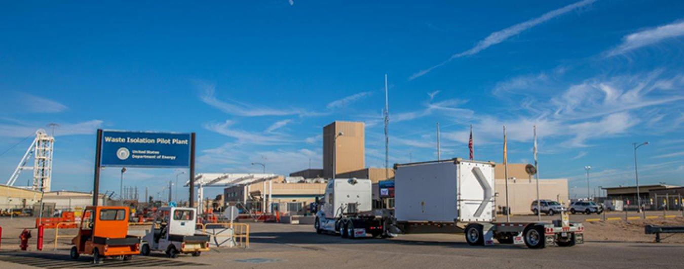 The tower in the background, at center, houses a waste hoist that transports transuranic waste to the WIPP repository, 2,150 feet below the surface.