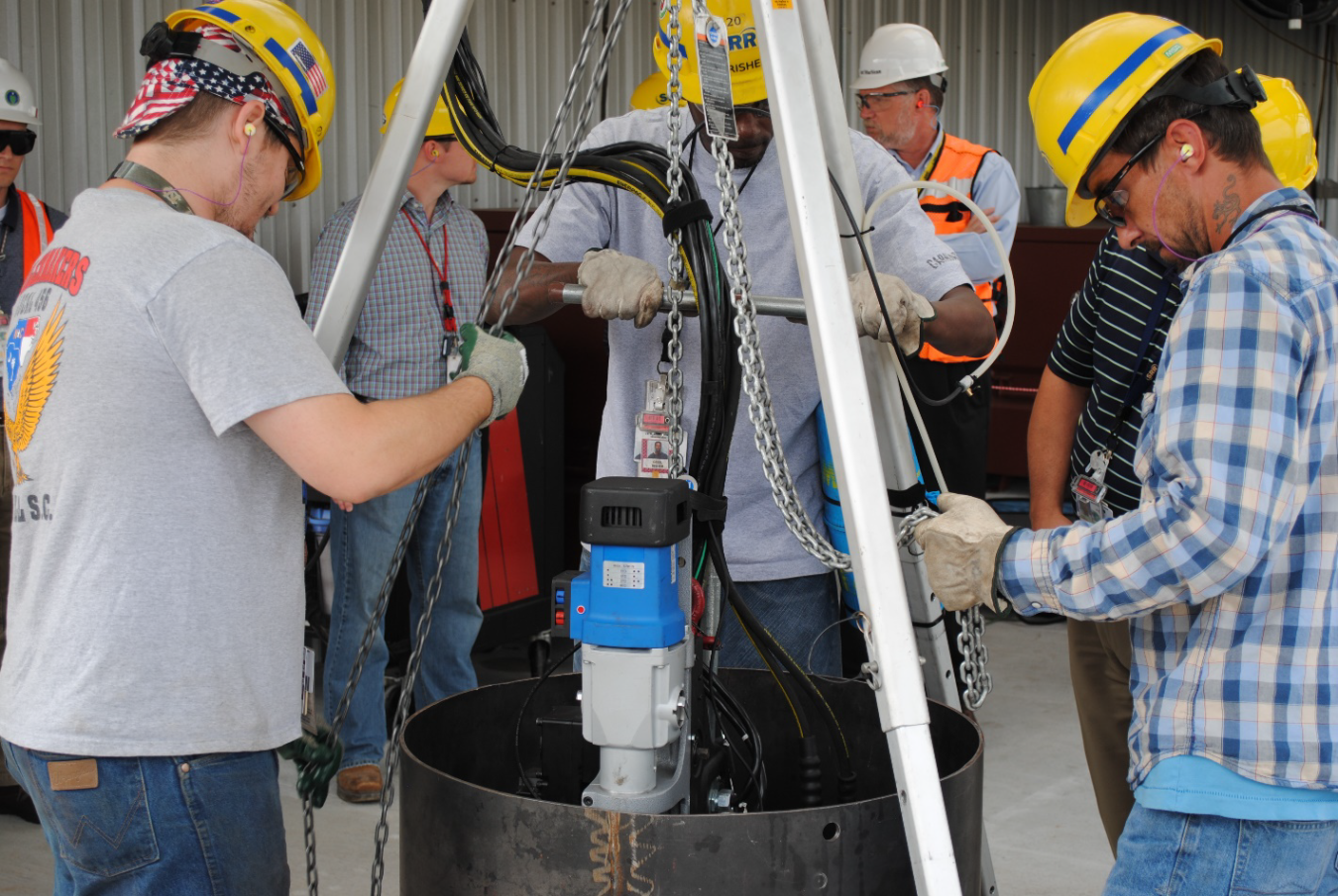 Workers test a modified cutting tool