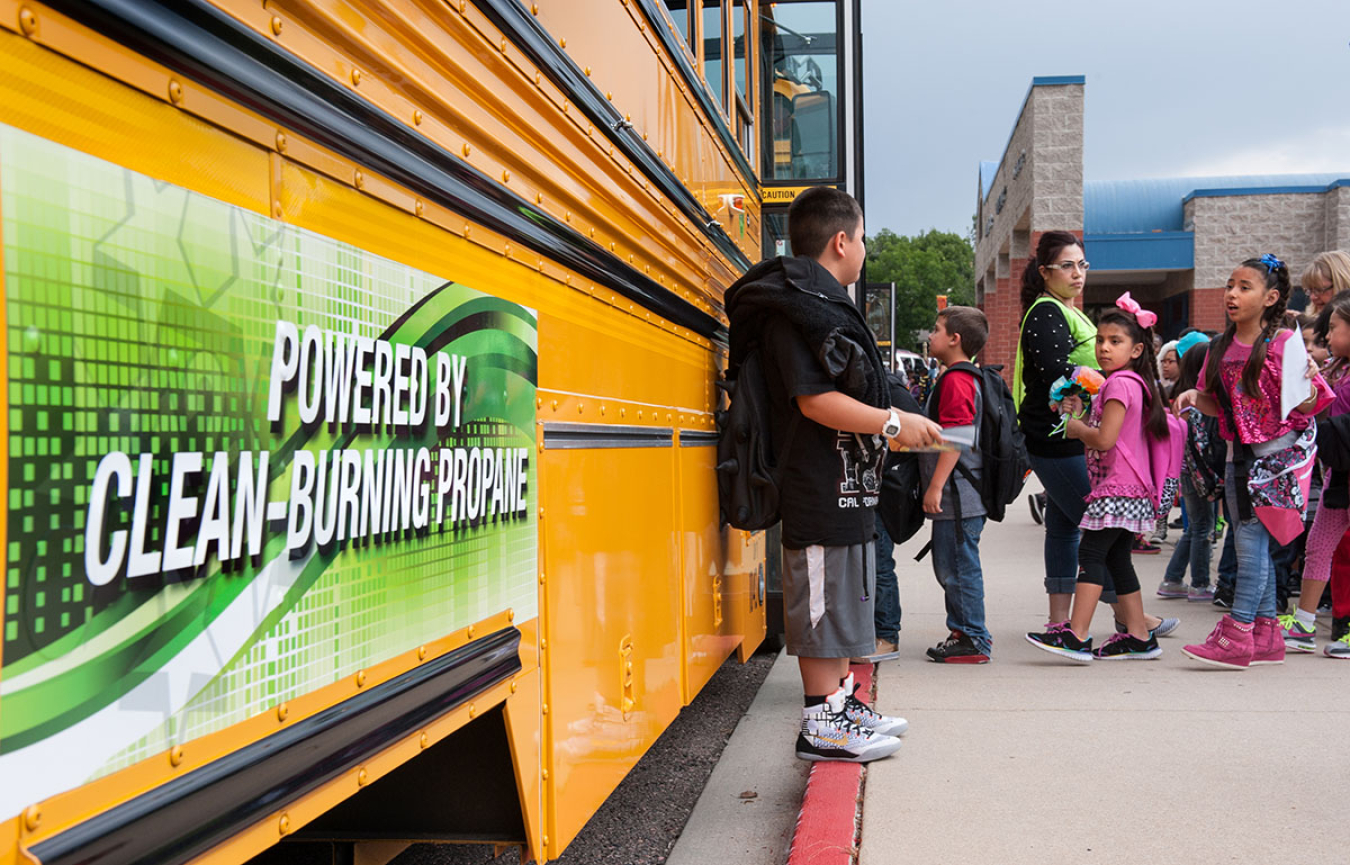 Children getting onto a school bus.
