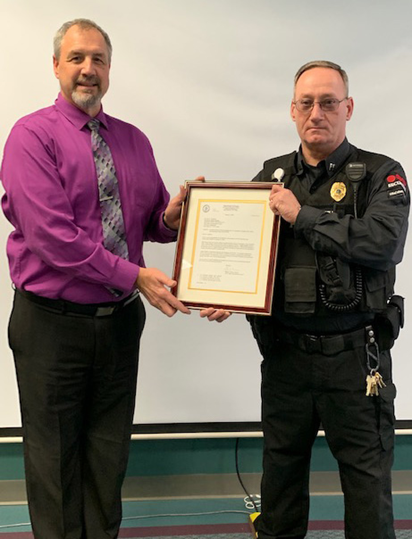 EM West Valley Demonstration Project (WVDP) Director Bryan Bower presents a plaque to Capt. James Madden during a ceremony at WVDP last week.